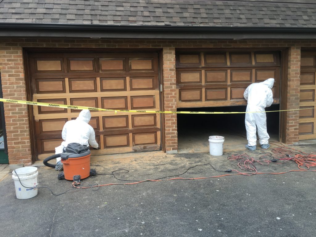 men renovating garage doors