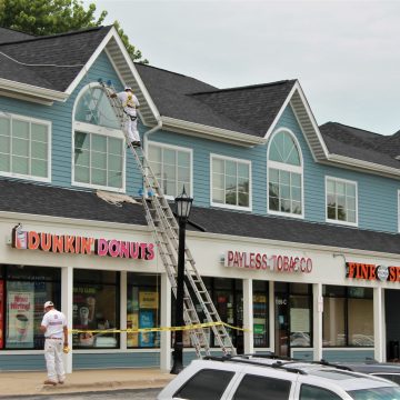 Man on ladder renovating building