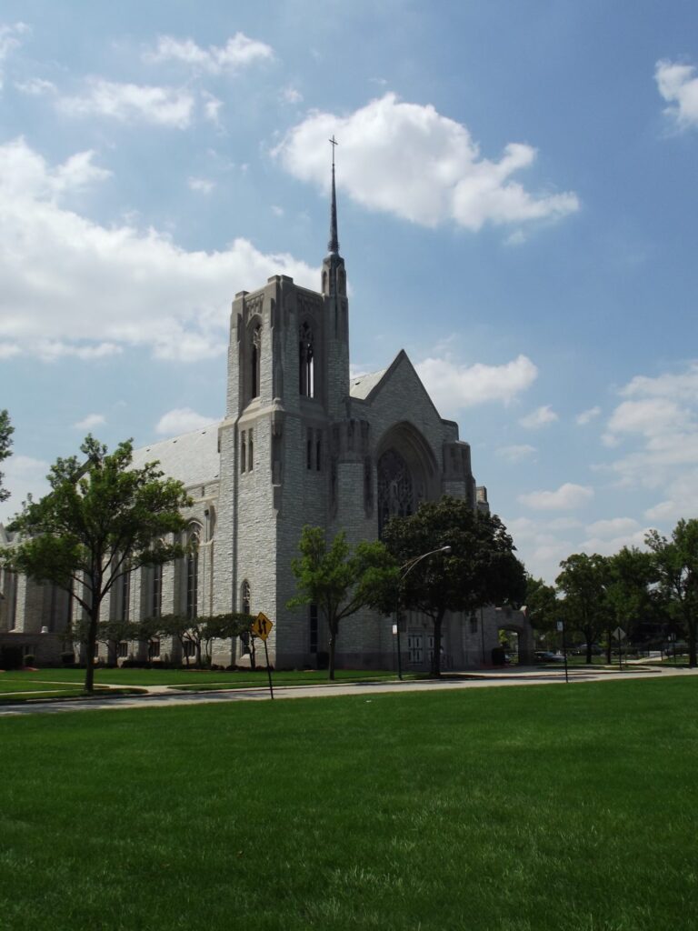Queen of All Saints Basilica in Chicago, a limestone Gothic church with stone tower and spire restored by Fortune Restoration